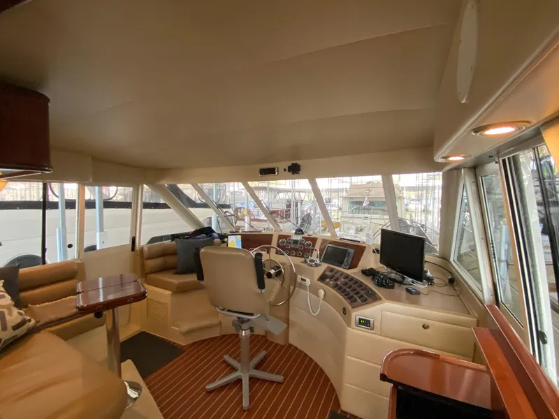 Slide: The Image of 2008 Meridian 490 Pilot House interior with helm, seating, and navigation equipment. - 23