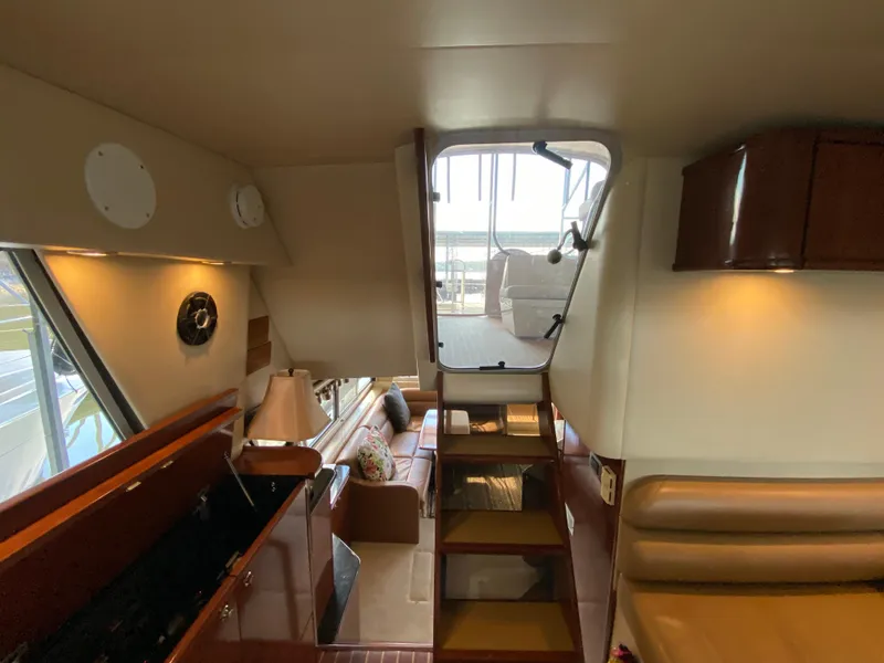 Slide: The Image of Interior of 2008 Meridian 490 Pilot House yacht, featuring cozy seating and elegant wood finishes. - 29