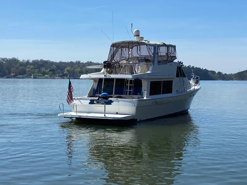 Slide: The Image of 2008 Meridian 490 Pilot House yacht on calm lake with American flag. - 3