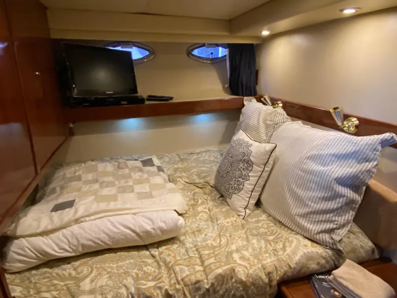 Slide: The Image of Cozy bedroom in 2008 Meridian 490 Pilot House yacht with TV and elegant bedding. - 31
