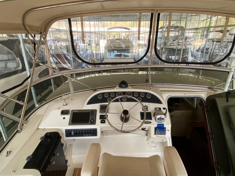 Slide: The Image of 2008 Meridian 490 Pilot House helm with steering wheel and navigation equipment. - 46