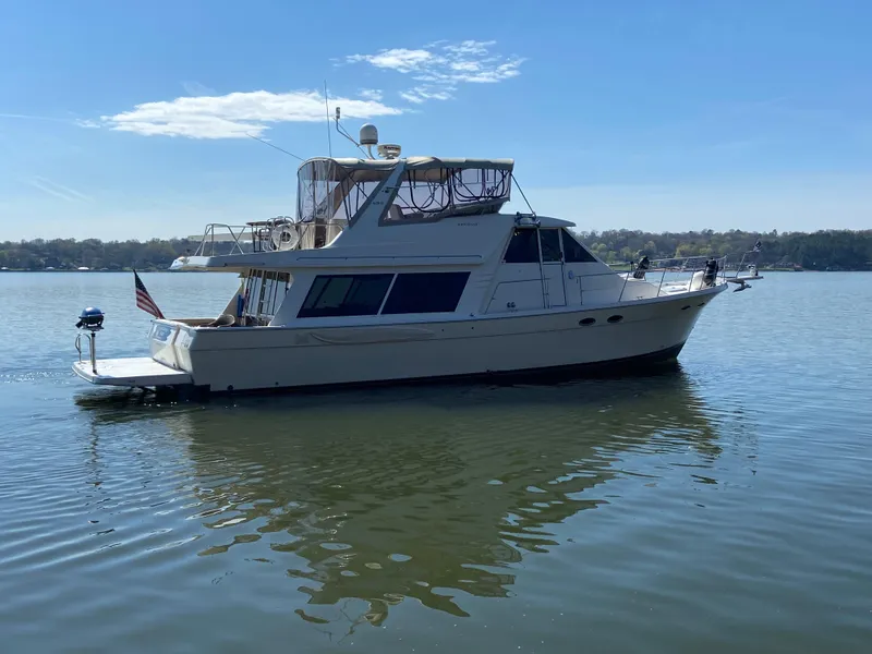 Slide: The Image of 2008 Meridian 490 Pilot House yacht on calm water under clear sky. - 5