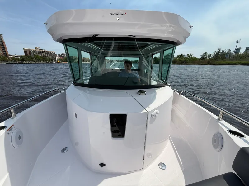 Slide: The Image of Axopar 28 CABIN 2021 boat on water, featuring sleek design and spacious cabin. - 18