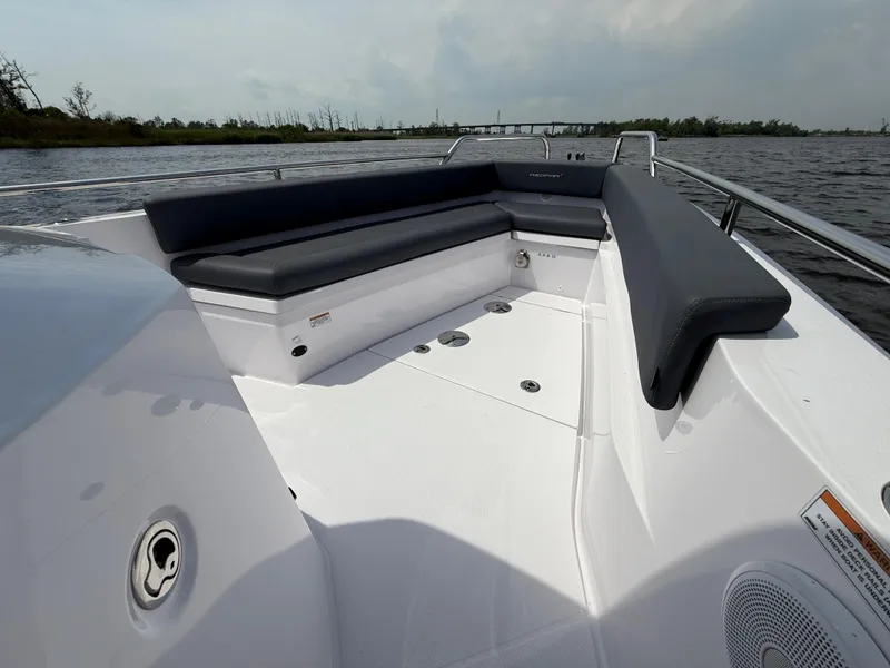 Slide: The Image of 2021 Axopar 28 CABIN boat with spacious seating on a calm waterway. - 23
