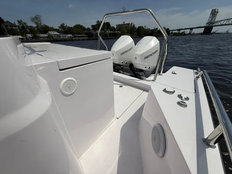 Slide: The Image of 2021 Axopar 28 CABIN boat with dual Mercury engines on a calm river. - 7