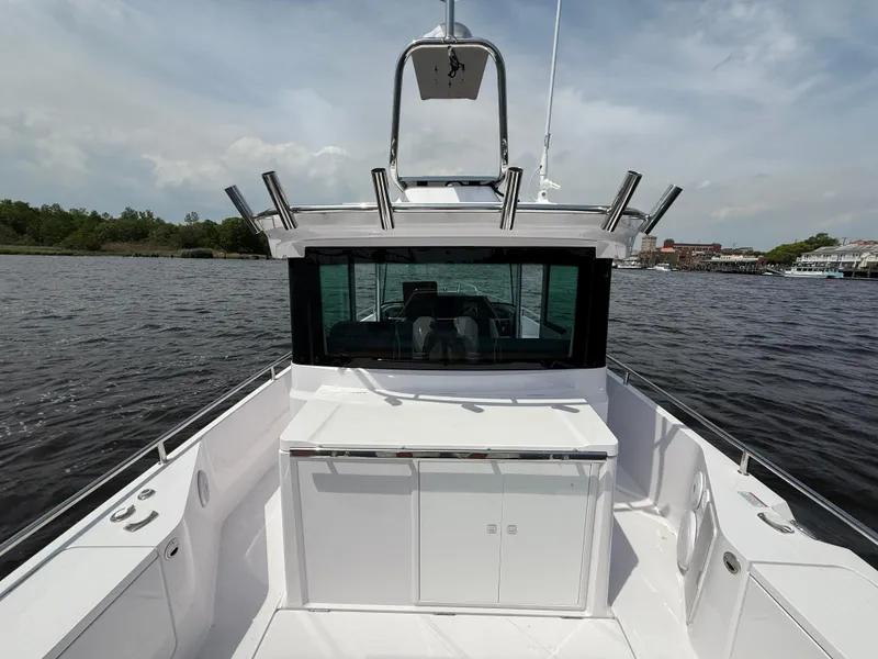 Slide: The Image of Axopar 28 CABIN 2021 boat on water, featuring sleek design and spacious deck. - 8