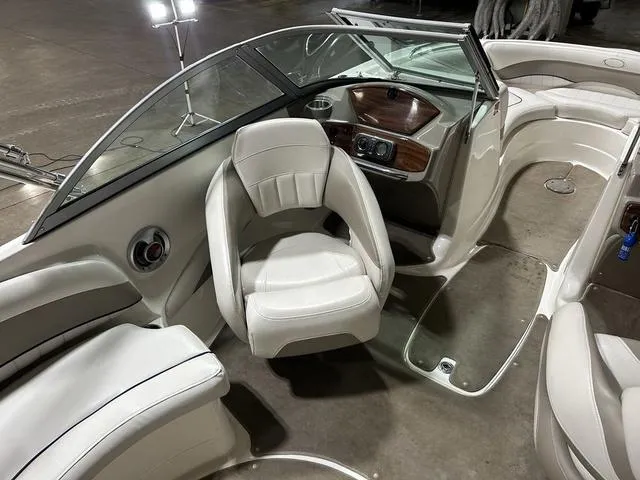 Slide: The Image of 2007 Kayot V220i boat interior with white seating and sleek dashboard design. - 13