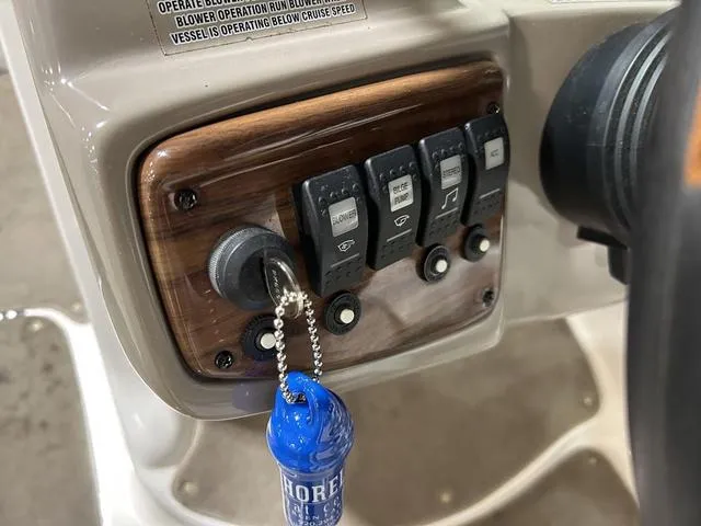 Slide: The Image of Control panel of a 2007 Kayot V220i boat with key and switches. - 16