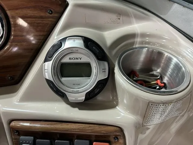 Slide: The Image of 2007 Kayot V220i dashboard with Sony stereo and cup holder. - 18