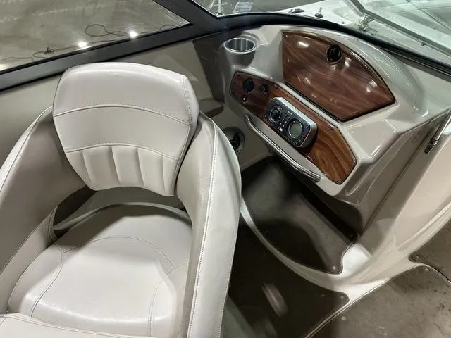 Slide: The Image of 2007 Kayot V220i boat interior with beige seating and wood-accented dashboard. - 19