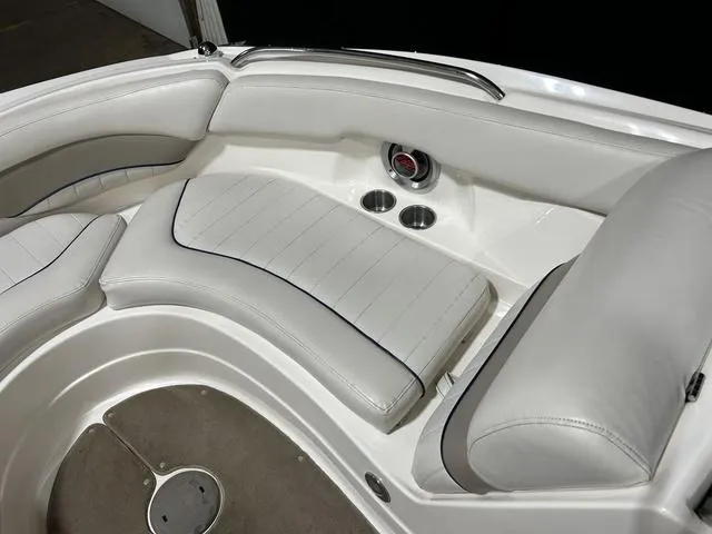 Slide: The Image of 2007 Kayot V220i boat interior with white cushioned seating and cup holders. - 21