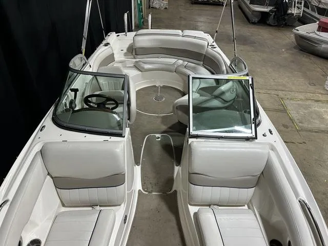 Slide: The Image of 2007 Kayot V220i boat with white seating and dual windshields in a warehouse setting. - 22