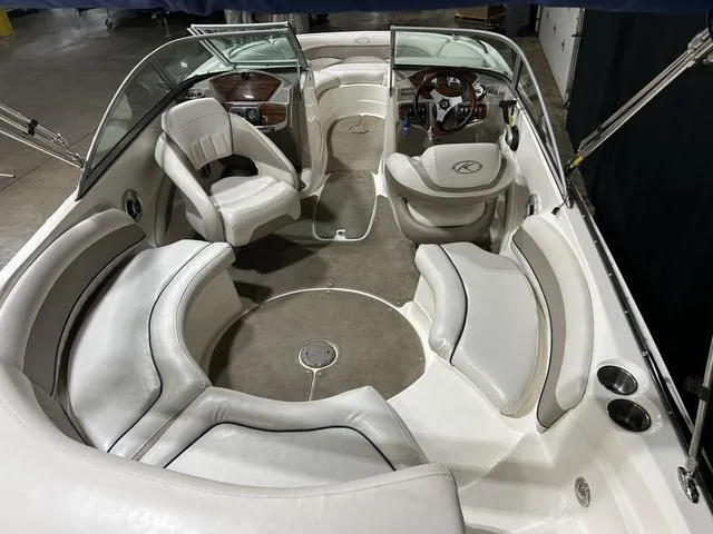 Slide: The Image of 2007 Kayot V220i boat interior with white leather seating and steering console. - 25