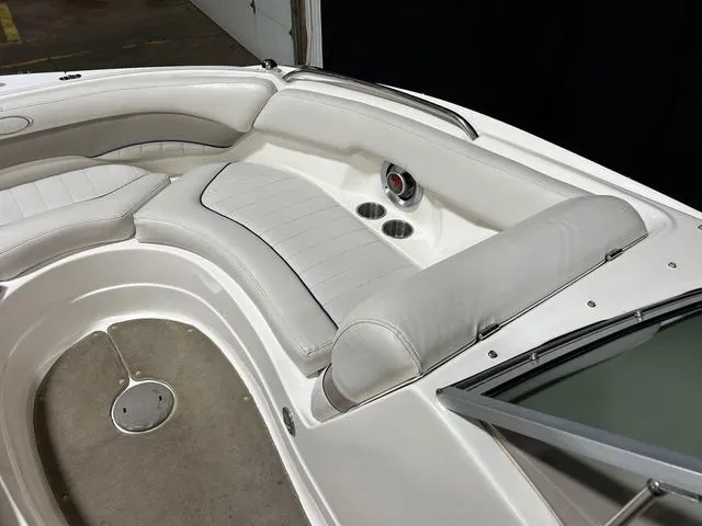 Slide: The Image of 2007 Kayot V220i boat interior with white cushioned seating and cup holders. - 27