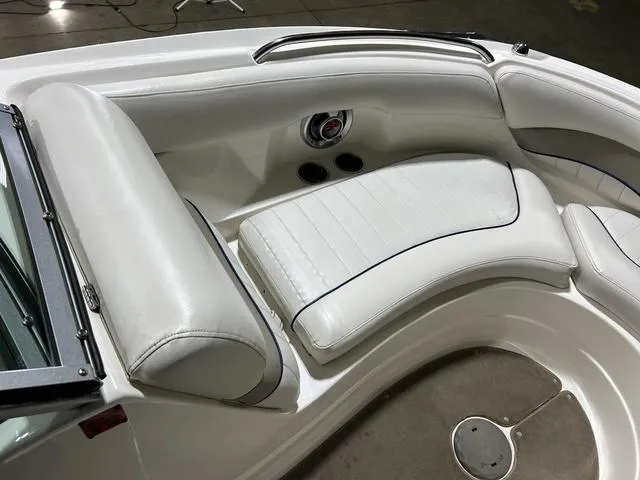 Slide: The Image of 2007 Kayot V220i boat interior with white leather seating and cup holders. - 30