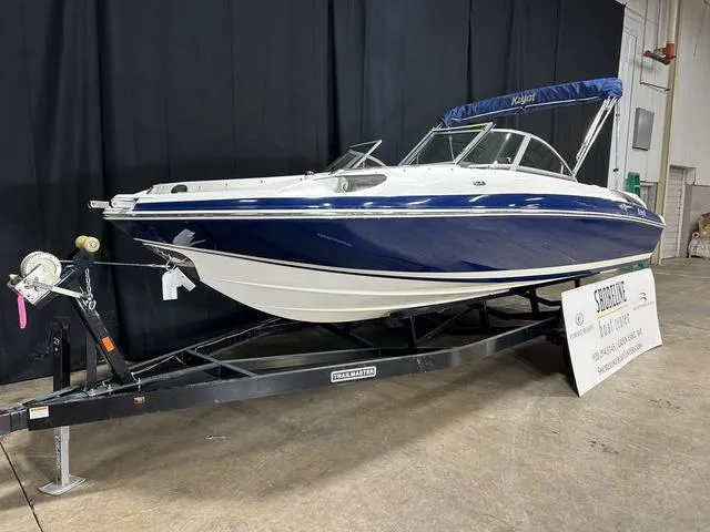 Slide: The Image of 2007 Kayot V220i boat on trailer, blue and white design, indoor display. - 5