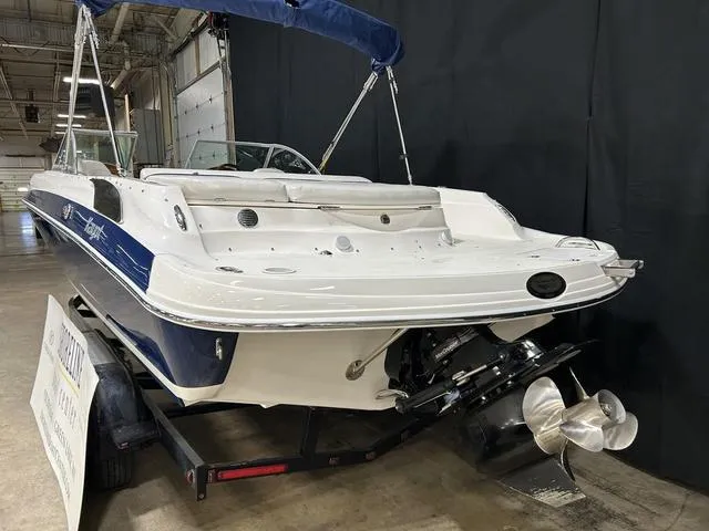 Slide: The Image of 2007 Kayot V220i boat on trailer, displayed indoors with blue and white exterior. - 9