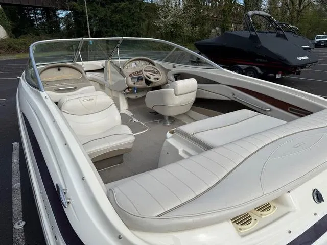 Slide: The Image of 2000 Maxum 2100SR boat interior with white seating and steering wheel. - 3