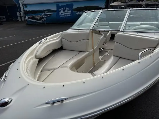 Slide: The Image of 2000 Maxum 2100SR boat with white interior seating, parked outdoors. - 4