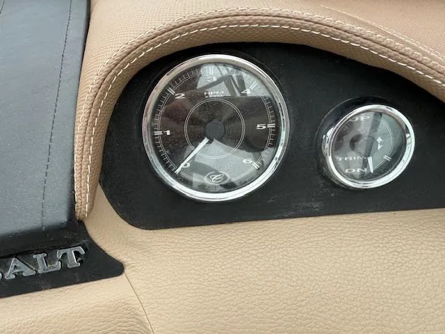 Slide: The Image of Dashboard of a 2012 Cobalt 220S boat with RPM gauges and beige leather trim. - 12