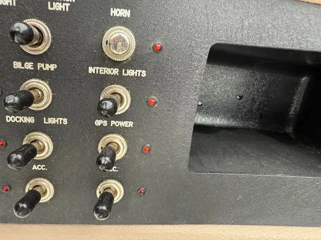 Slide: The Image of Control panel of a 2012 Cobalt 220S boat with various switches and indicators. - 13