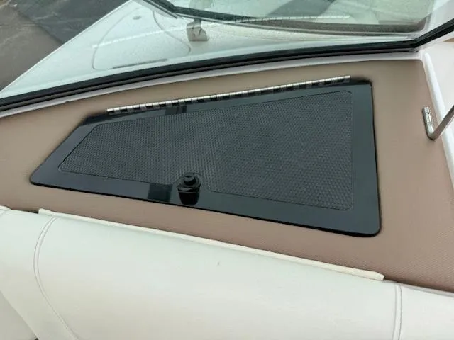 Slide: The Image of 2012 Cobalt 220S boat dashboard with black panel and beige trim. - 14