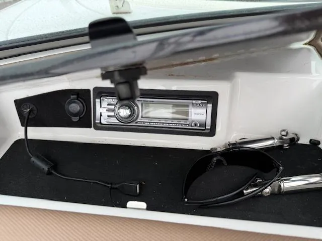 Slide: The Image of Interior of a 2012 Cobalt 220S boat with stereo and sunglasses. - 15