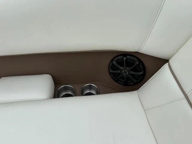 Slide: The Image of White leather interior of 2012 Cobalt 220S boat with speaker and cup holders. - 16