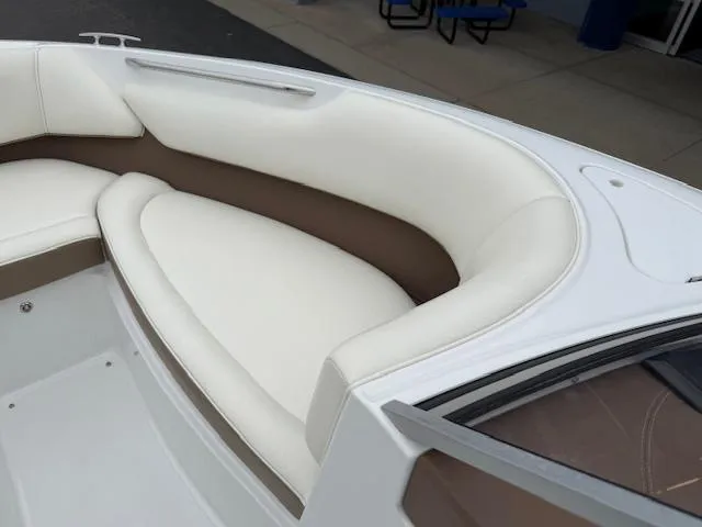 Slide: The Image of 2012 Cobalt 220S boat interior with white and brown cushioned seating. - 17