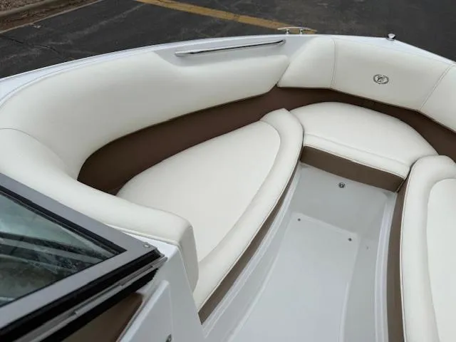 Slide: The Image of 2012 Cobalt 220S boat interior with white and brown seating. - 18