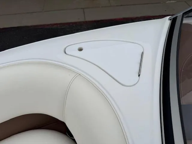 Slide: The Image of Cobalt 220S 2012 boat interior with white and beige seating detail. - 19