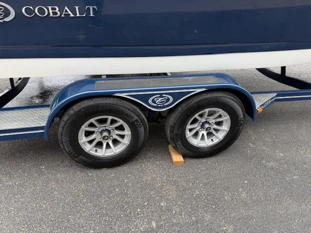 Slide: The Image of Trailer of a 2012 Cobalt 220S boat with dual wheels on pavement. - 23