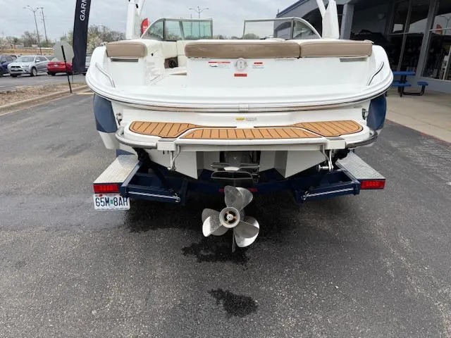 Slide: The Image of Rear view of a 2012 Cobalt 220S boat on a trailer, showcasing propeller and swim platform. - 3