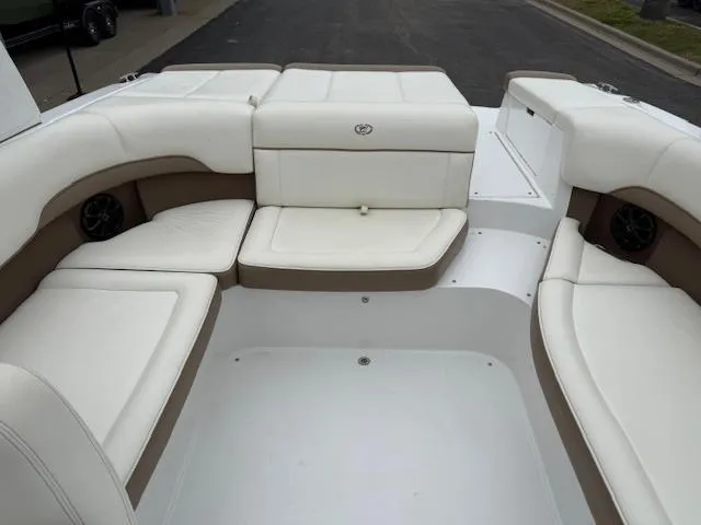 Slide: The Image of 2012 Cobalt 220S boat interior with white and beige seating, spacious layout. - 6