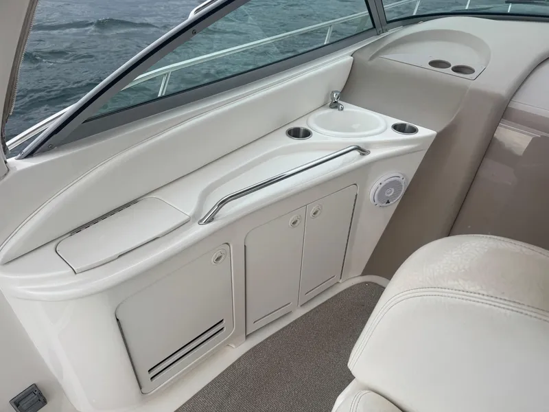 Slide: The Image of Interior view of a 2000 Sea Ray 340 Sundancer boat with white seating and storage. - 10