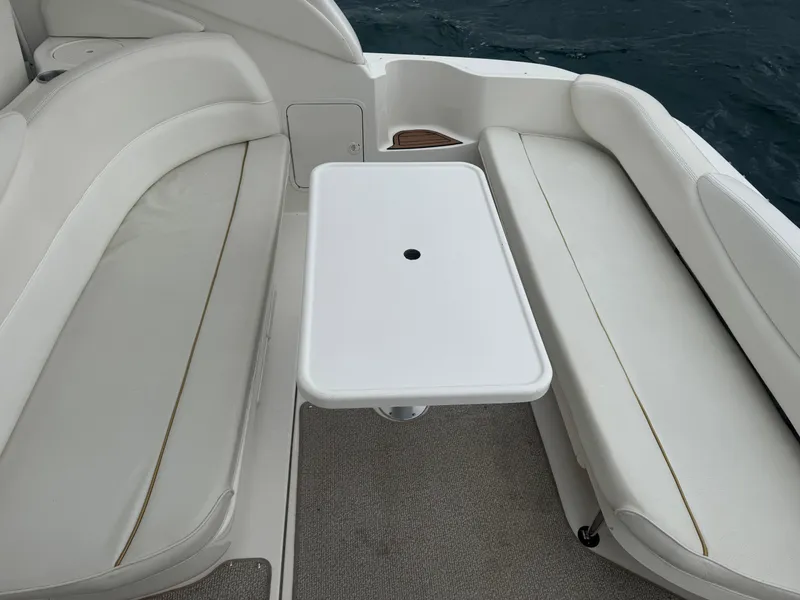 Slide: The Image of 2000 Sea Ray 340 Sundancer boat interior with white seating and table. - 12