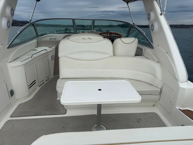 Slide: The Image of 2000 Sea Ray 340 Sundancer boat interior with seating and table on open water. - 14