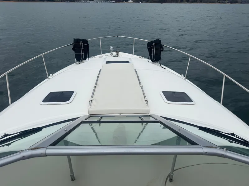 Slide: The Image of Bow view of 2000 Sea Ray 340 Sundancer yacht on calm water. - 16