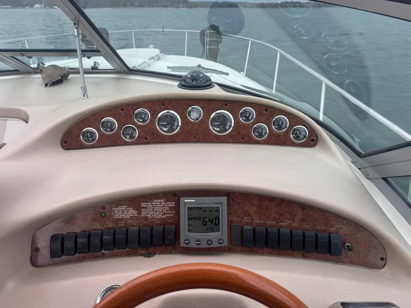 Slide: The Image of Dashboard of a 2000 Sea Ray 340 Sundancer boat with gauges and controls. - 18