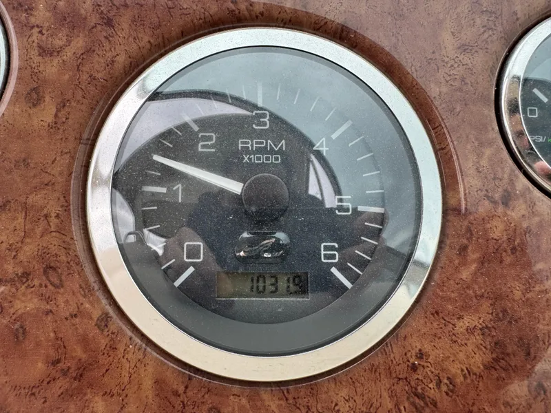 Slide: The Image of Tachometer of 2000 Sea Ray 340 Sundancer showing 1031.9 RPM on wood grain dashboard. - 19