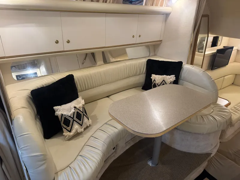 Slide: The Image of Interior of 2000 Sea Ray 340 Sundancer with plush seating and dining table. - 24