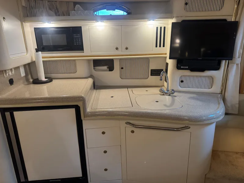 Slide: The Image of Interior of 2000 Sea Ray 340 Sundancer yacht kitchen with appliances and sink. - 25