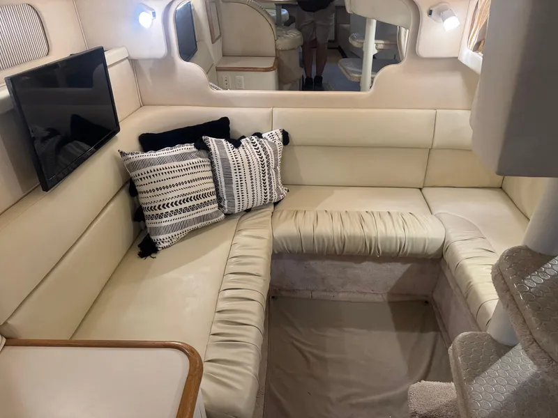 Slide: The Image of Interior of 2000 Sea Ray 340 Sundancer with cream seating and decorative pillows. - 27