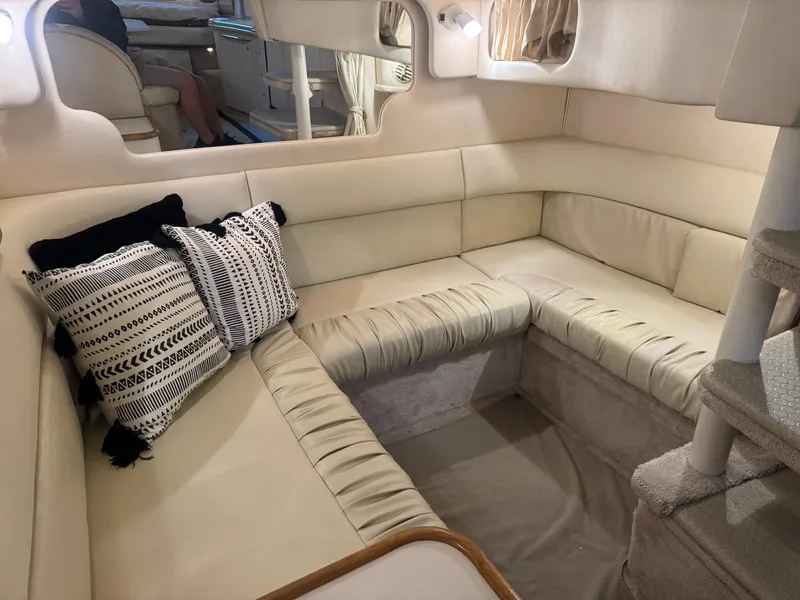 Slide: The Image of Interior of 2000 Sea Ray 340 Sundancer with beige seating and decorative pillows. - 28