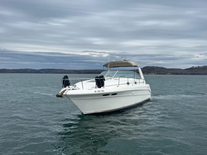 Slide: The Image of 2000 Sea Ray 340 Sundancer boat on calm water under cloudy sky. - 4