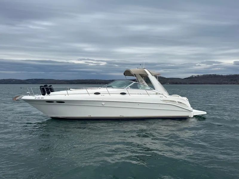 Slide: The Image of 2000 Sea Ray 340 Sundancer boat on calm water under cloudy sky. - 5