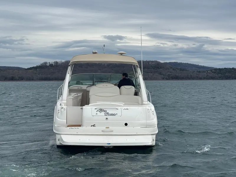 Slide: The Image of 2000 Sea Ray 340 Sundancer cruising on a lake under cloudy skies. - 7