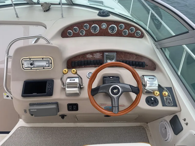 Slide: The Image of Cockpit of 2000 Sea Ray 340 Sundancer with steering wheel and control panel. - 8