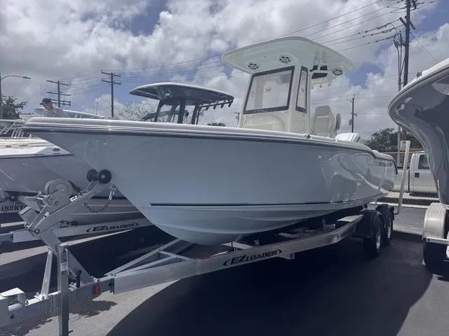 Slide: The Image of 2025 Key West 239 FSR boat on trailer under cloudy sky. - 1