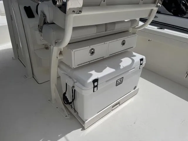 Slide: The Image of 2025 Key West 239 FSR boat interior with storage compartments and cooler. - 10